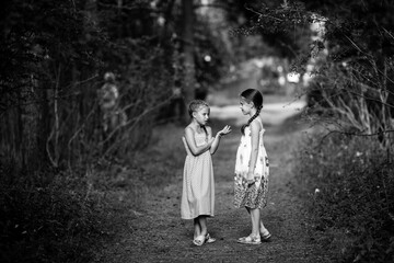 Fototapeta premium little friends excitedly talking standing in the Park. Black and white photography.
