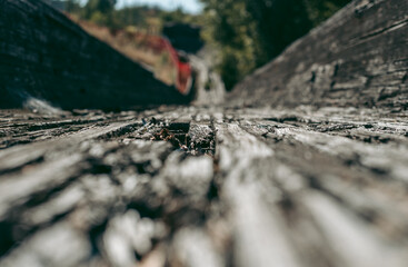 Old abandoned wooden bobsleigh track in summer by daylight