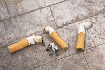 Cigarette butts on the desk. Bad habit concept