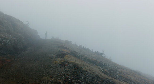 Person silhouette in mists of volcano