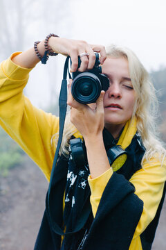 Young female taking photo on volcano