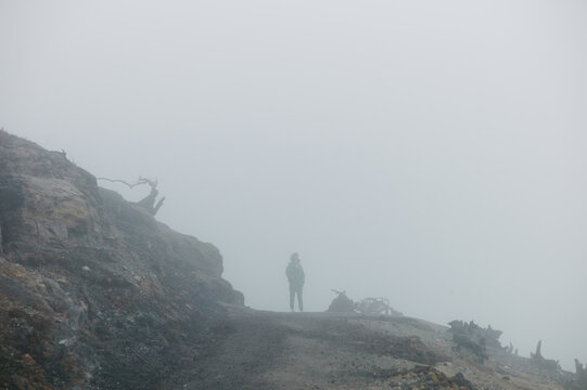 Person silhouette in mists of volcano