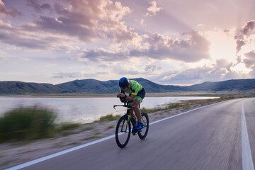 triathlon athlete riding bike - obrazy, fototapety, plakaty
