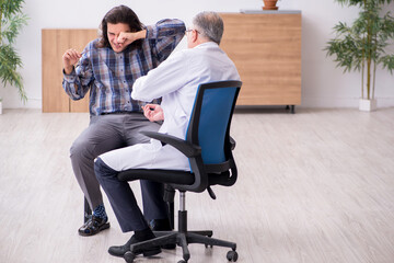 Young male patient visiting experienced doctor psychiatrist