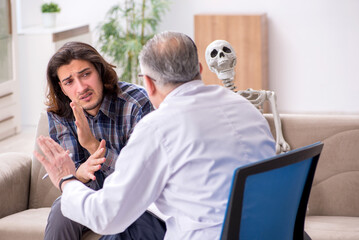 Young male patient visiting experienced doctor psychiatrist