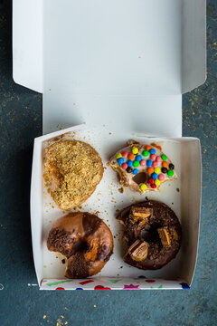 4 donuts with bites taken out