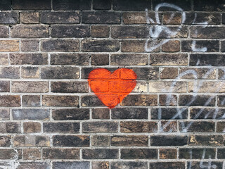 Red Heart painted on a brick wall