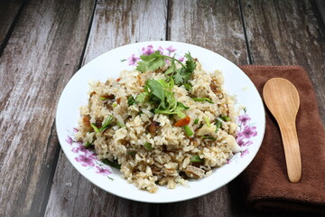 Traditional fried rice with chilly and dried fish, sliced shallot and topping with fresh coriander on the plate. Famous spicy street food menu in Asia.