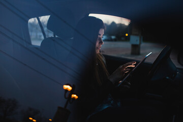 Business woman using digital tablet in the car