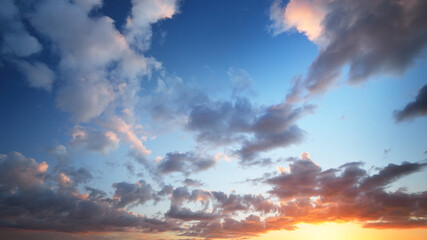 Clear blue sunset sky with colorful cumulus clouds. Abstract natural pattern, texture, close-up....
