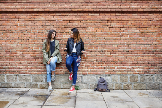 Girlfriends at brickwall.