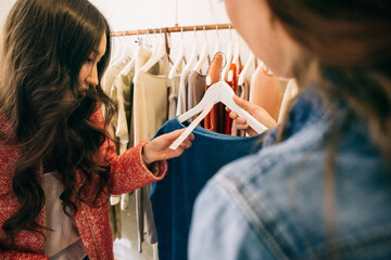 Fashion Shopping - Female Customer Holding Price Tag/Label on Blue Top