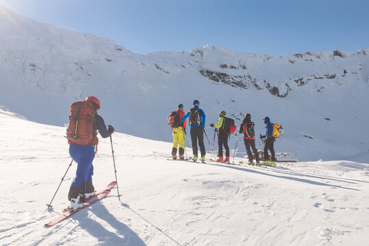 Group of people ski touring in mountains