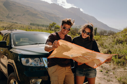 Couple on road trip looking for best route on map