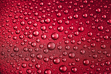 Fototapeta premium Red texture of water drops on the metal surface. Close-up macrophotography of wet droplets.