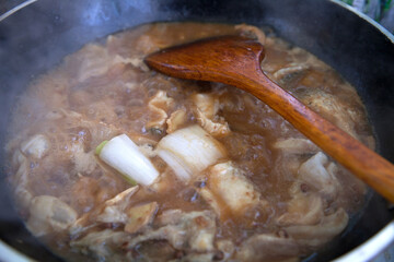 Stewed fish cubes in iron pan with miso