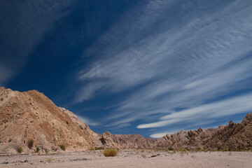 Desert landscape. Vie of the sand, rock and sandstone formations under a beautiful deep blue sky. 