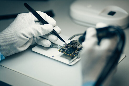 Man repairing smartphone.