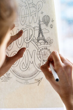 Painter tracing picture on window