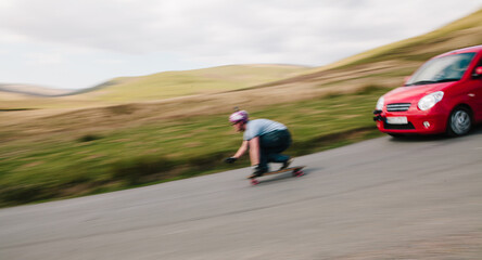 Motion blur of a longboarder being pursued by a camera car