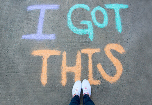Person standing over chalk words that say I Got This