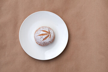 Pattern of cannabis leaf made with powdered sugar on the cookies on kraft background. Cannabis live resin extraction. Banner