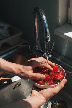 Man rinsing strawberries
