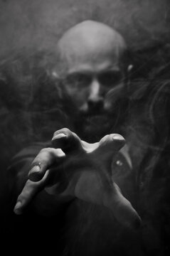 Scary Man Reaching Out Through The Smoke And Darkness