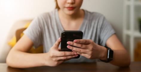 Woman holding a smartphone and using social media on internet.