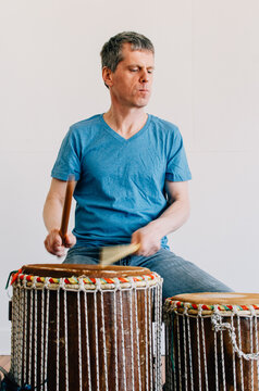 man playing his hand drums