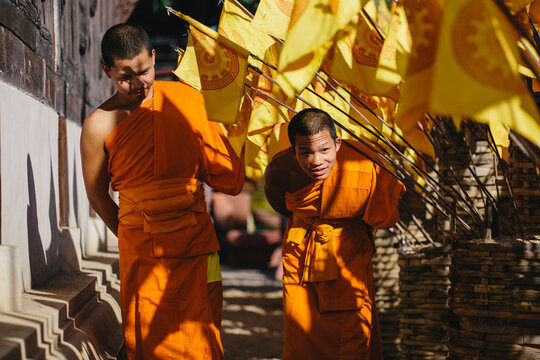 Young Buddhist monks walking out of the temple - Powered by Adobe