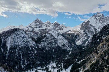 aerial snow covered mountain peaks in alps at winter 