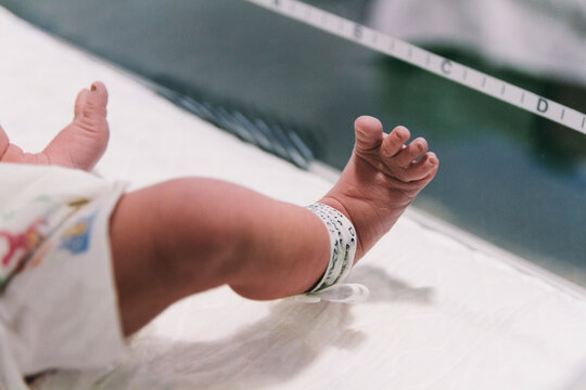Feet of newborn baby on doctors examination table