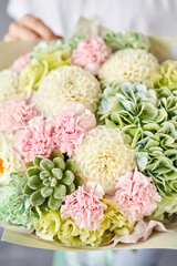 Beautiful bouquet of mixed flowers in woman hand. Floral shop concept . Handsome fresh bouquet. Flowers delivery.