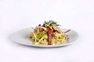 Fresh cabbage salad, green canned peas and cut into strips of servellat , seasoned with mayonnaise sauce isolated on a white background