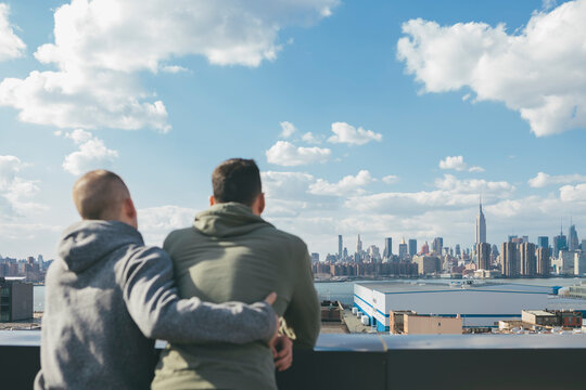 Gay Men Friends Hanging Out on a Rooftop Enjoying the View in New York