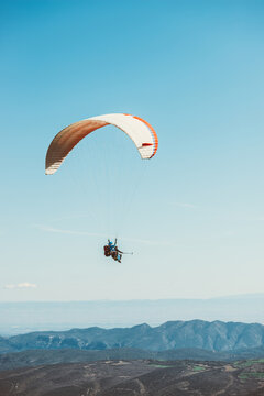 Man practicing paragliding on the mountains
