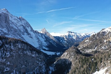 aerial snow covered mountain peaks in alps at winter 
