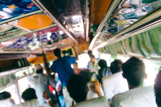 People travelling on a colourful bus in India