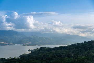 Dam in colombia surrounded by lush vegetation and with a bridge