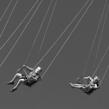 boy and girl on wave swinger ride