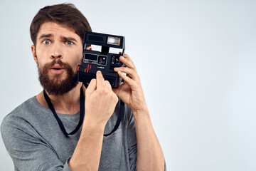 Fototapeta premium male photographer holding camera professional lens creative studio work light background