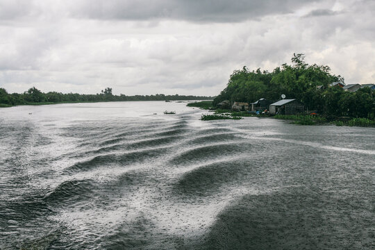 Rain and storm on a lake with waves produced by a boat