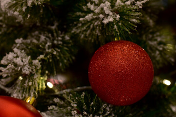 Closeup of Christmas Ball on Christmas Tree with bokeh beautiful background for design and decoration, new year concept, selective focus.