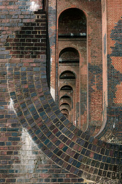 Curved receding interior arched columns of a railway viaduct