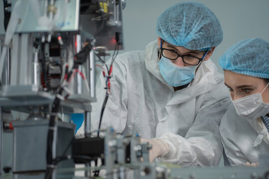 inovation design engineer and doctor team Diverse industries Expert, Programming, and Robotic Hand Handling Bright hi-tech facility Scientists in sterile clothing working on computers