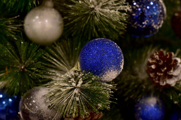 Closeup of Christmas Ball on Christmas Tree with bokeh beautiful background for design and decoration, new year concept, selective focus.