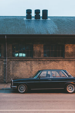 oldtimer car parking in front of a factory