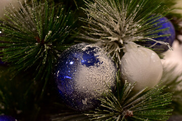 Fototapeta na wymiar Closeup of Christmas Ball on Christmas Tree with bokeh beautiful background for design and decoration, new year concept, selective focus.