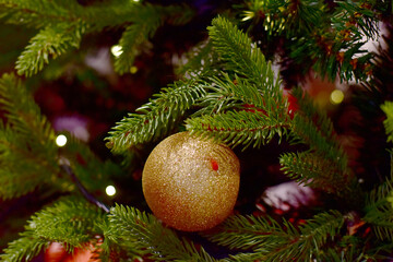 Closeup of Christmas Ball on Christmas Tree with bokeh beautiful background for design and decoration, new year concept, selective focus.